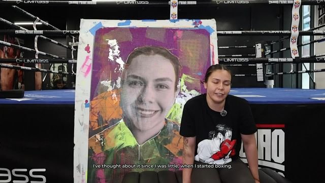 Brianda Tamara seated beside artwork during her Rooted in Los Angeles interview