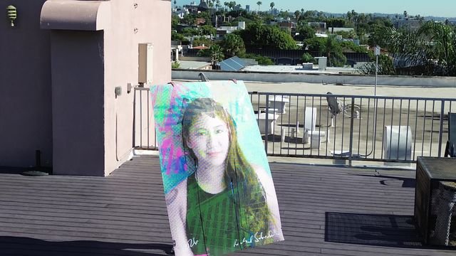 Alyssa San Augustine, amateur boxer, holding artwork for Rooted in Los Angeles